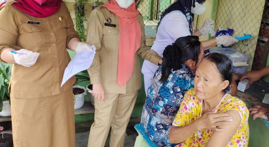 Camat Bintang Bayu Fitrianti Haharap (tengah) bersama Kepala Puskesmas Erna Ningsih melakukan vaksinasi secara door to door ke masyarakat,Selasa (7/12/2021).