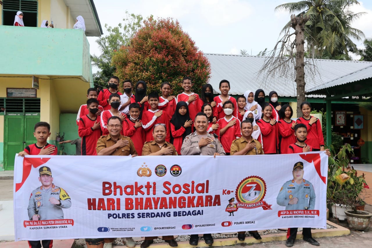 Bripka Juparto Situmorang dari Humas Polres Sergai bersama siswa SMP Negeri 1 Perbaungan dalam kegiatan bakti sosial Police Goes to school dalam rangka hari Bhayangkara ke -76.