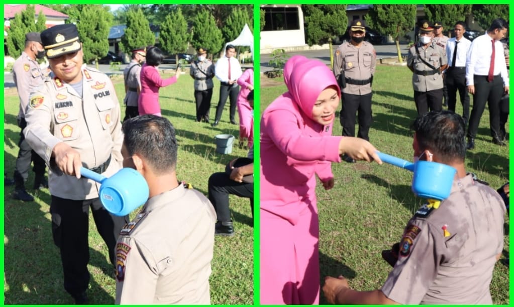 Kapolres Sergai AKBP Ali Machfud berserta istri melakukan prosesi guyuran air bunga pada upacara Korps Raport kepada 27 personil.
